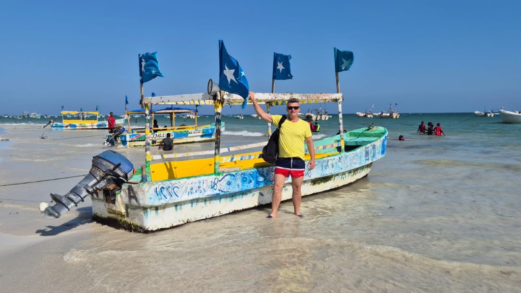 Colorful boat flying Somali flags on the beach